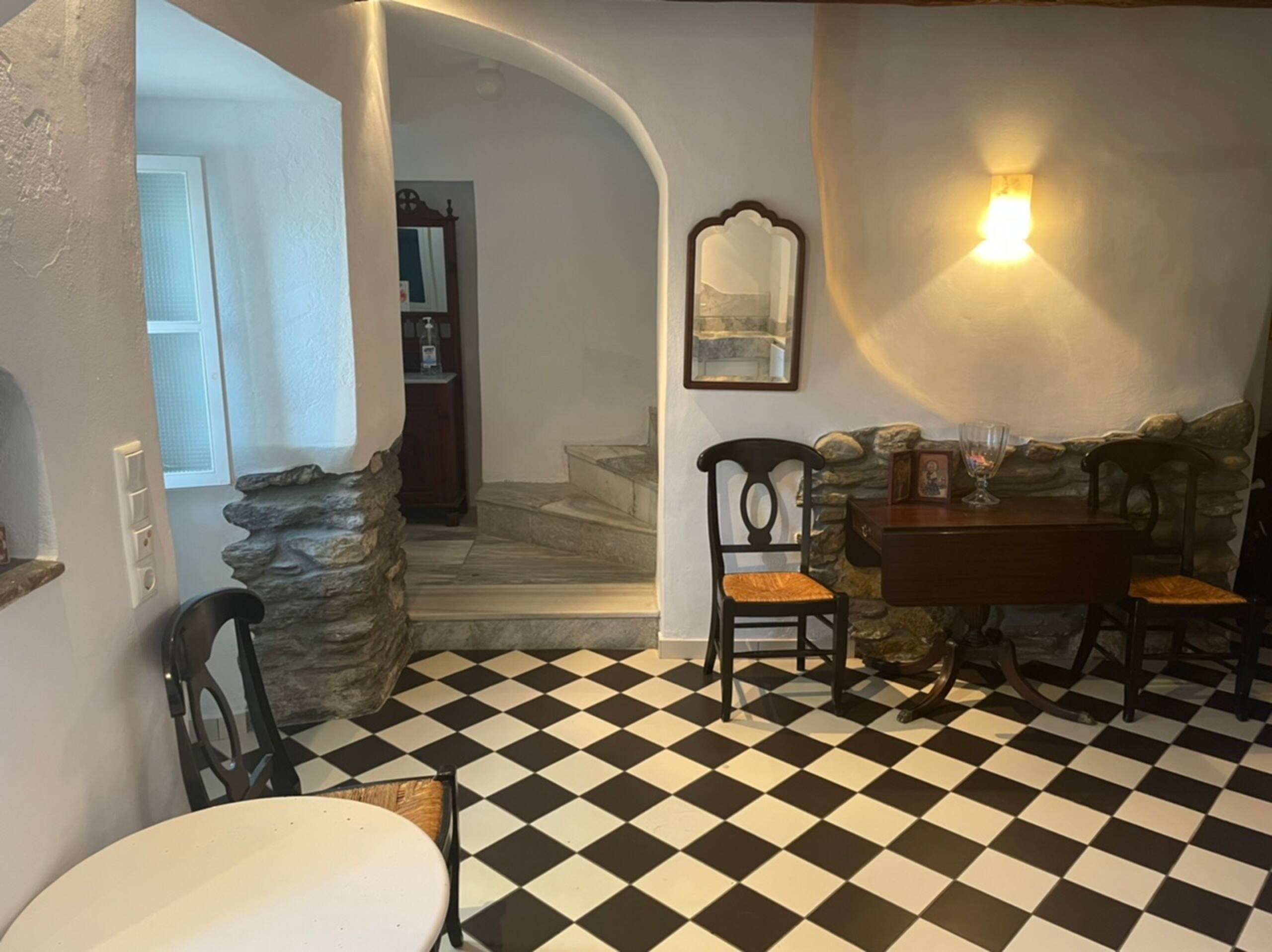Checkerboard dining nook with staircase detail