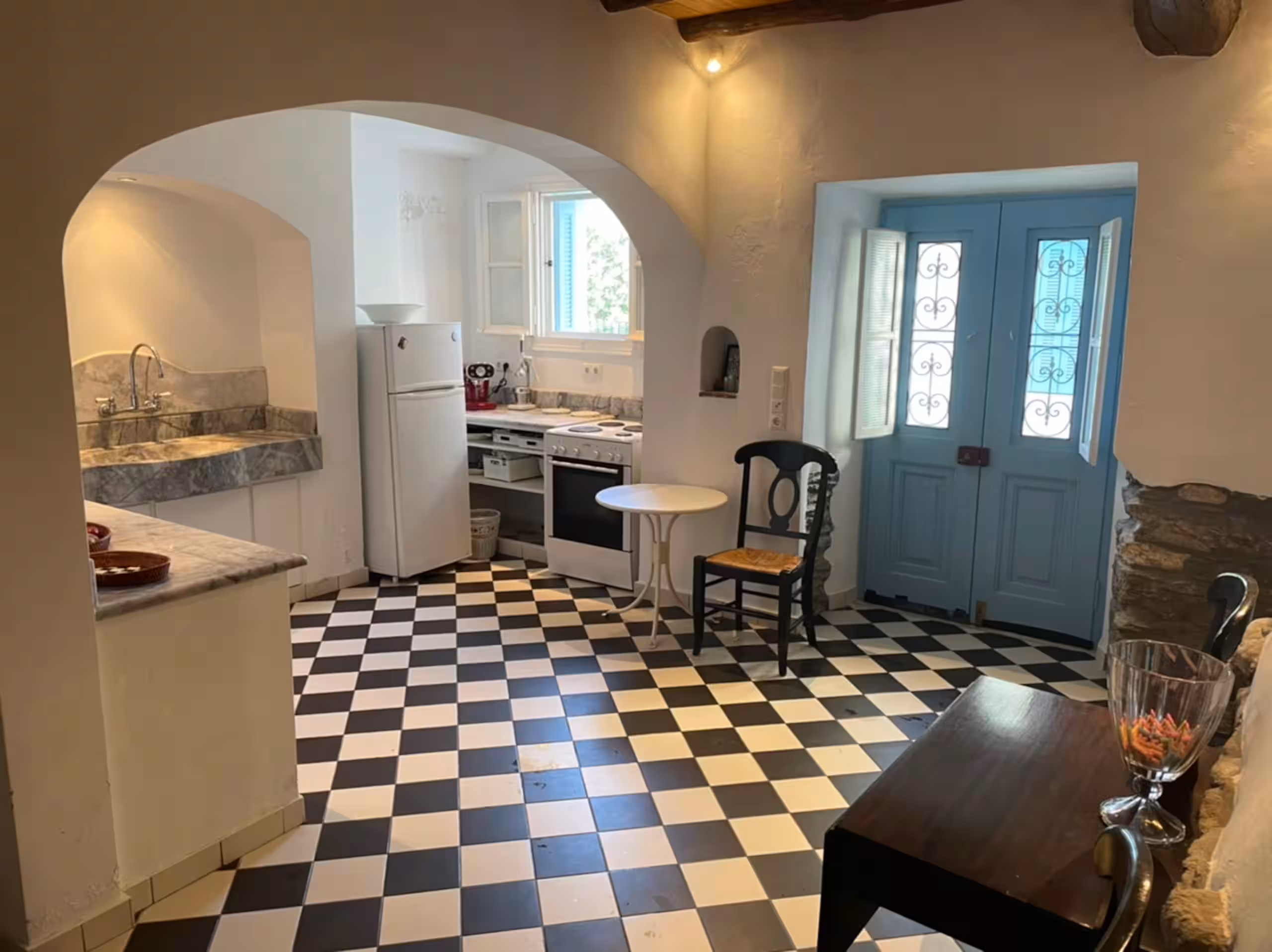 Open-plan kitchen and entry with original stonework
